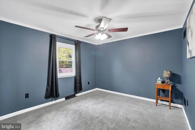 a view of a room with a fan and a large window