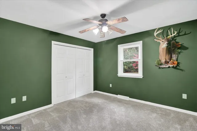 an empty room with windows and closet