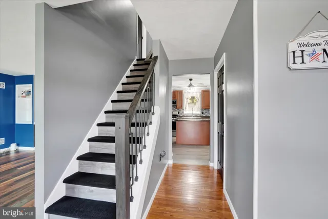 a view of entryway and hall with wooden floor