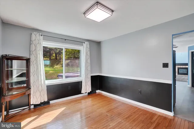 a big room with wooden floor and windows