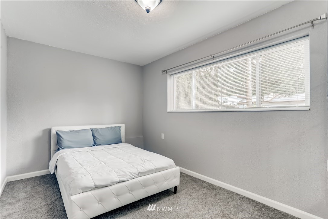 2015 181st Street Southeast Bothell, WA 98012 - Photo 14 of 20 a bedroom with a bed and window