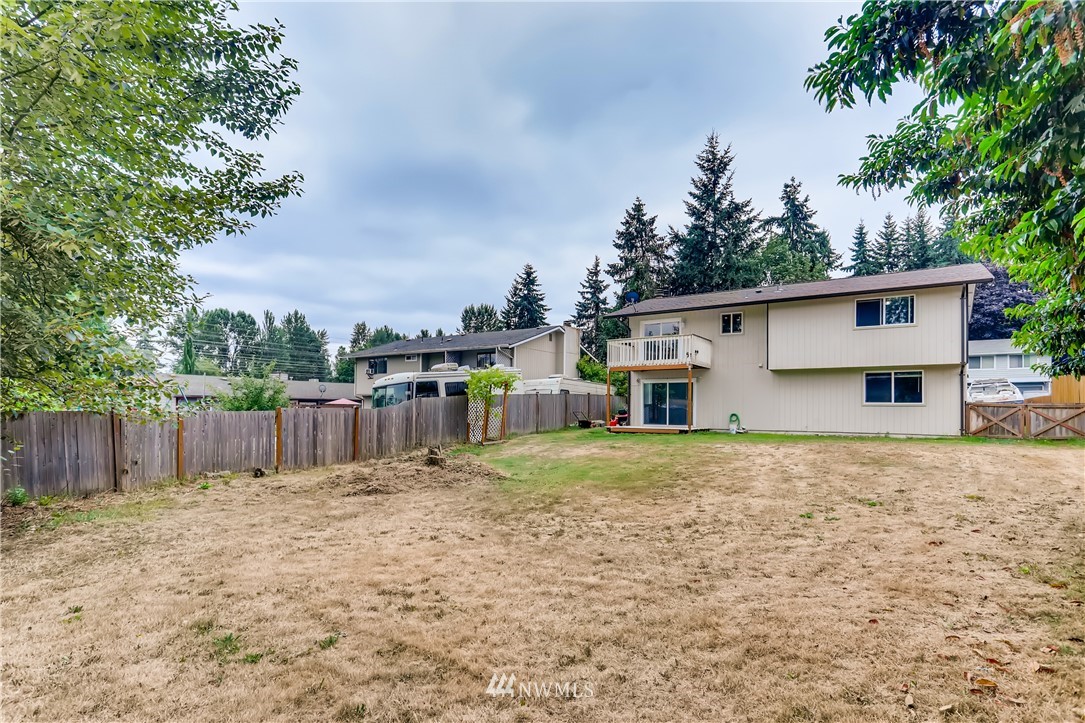 2015 181st Street Southeast Bothell, WA 98012 - Photo 20 of 20 a backyard of a house with wooden fence