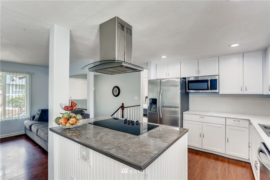2015 181st Street Southeast Bothell, WA 98012 - Photo 4 of 20 a kitchen with stainless steel appliances granite countertop a sink stove and refrigerator