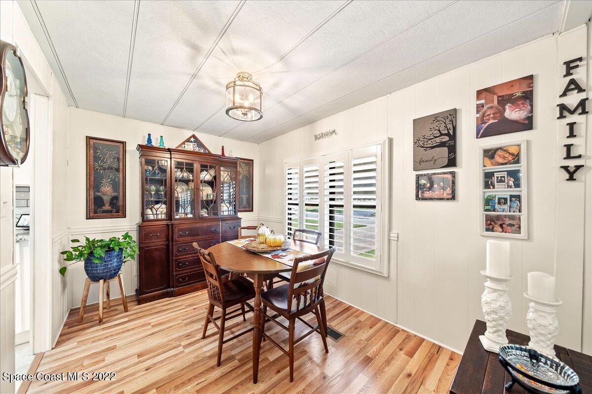 3256 Nancy Avenue Mims, FL 32754 - Photo 17 of 36 a view of a dining room with furniture window and wooden floor