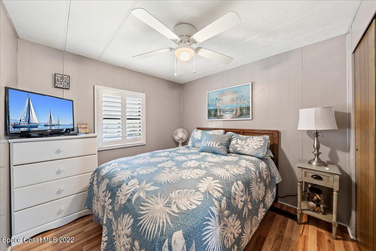 3256 Nancy Avenue Mims, FL 32754 - Photo 27 of 36 a bedroom with a bed and a flat screen tv