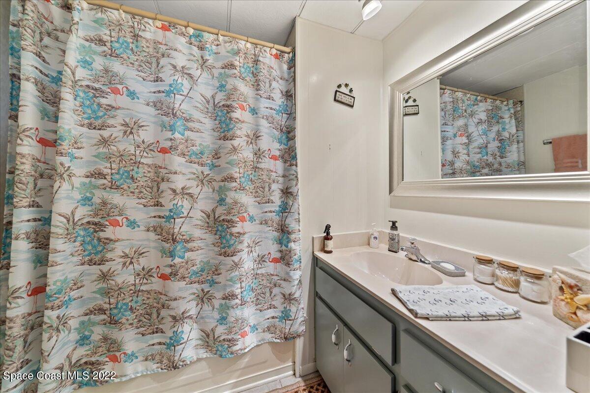 3256 Nancy Avenue Mims, FL 32754 - Photo 28 of 36 a bathroom with a granite countertop sink and a mirror