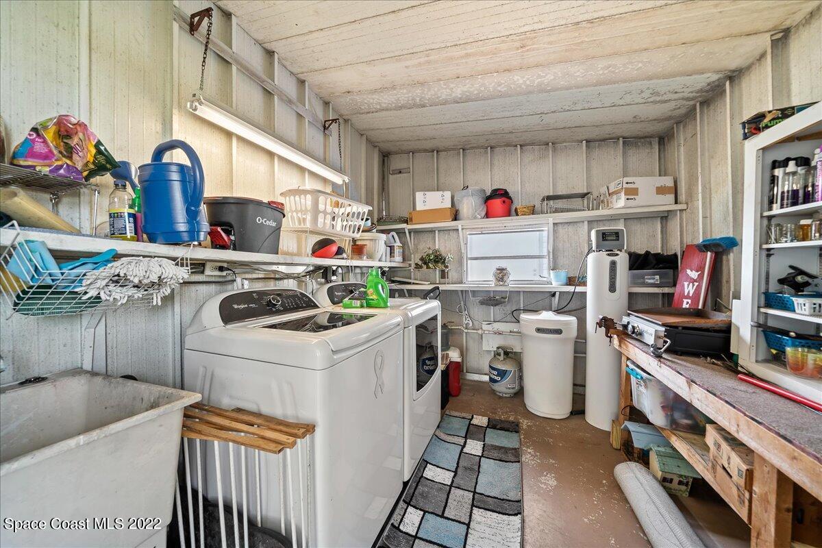 3256 Nancy Avenue Mims, FL 32754 - Photo 29 of 36 a utility room with cabinets dryer and washer