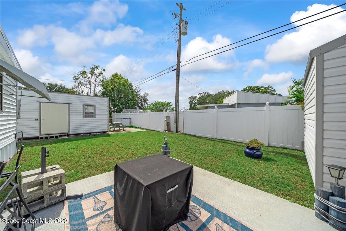 3256 Nancy Avenue Mims, FL 32754 - Photo 30 of 36 a view of a backyard with couches plants and large tree