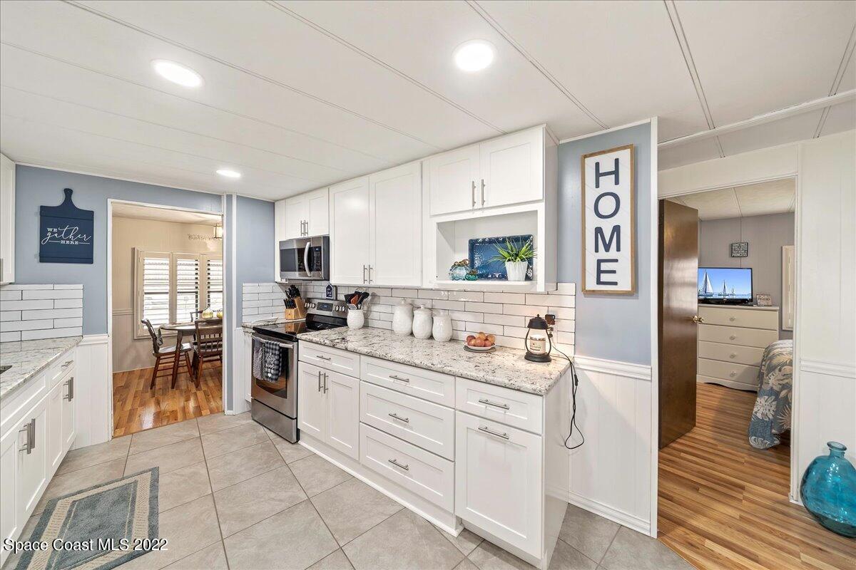 3256 Nancy Avenue Mims, FL 32754 - Photo 8 of 36 a kitchen with a sink stove and cabinets
