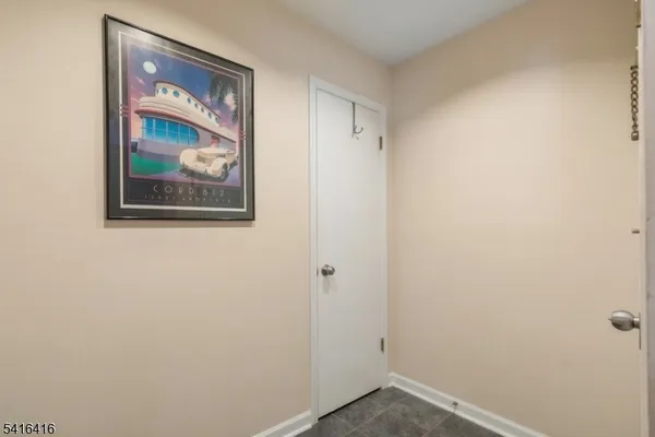a view of a small space with wooden floor and a window