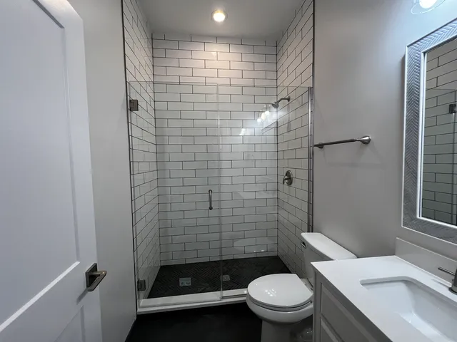 a bathroom with a toilet and a shower