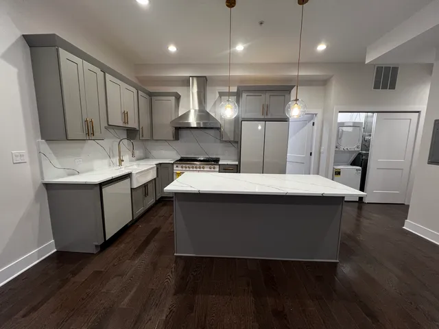 a kitchen with a sink stainless steel appliances and cabinets