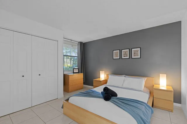 a bedroom with a bed and a potted plant