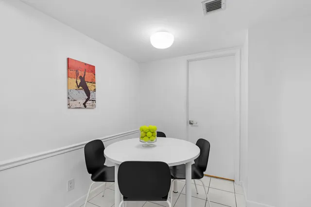 a view of a dining room with furniture and a potted plant