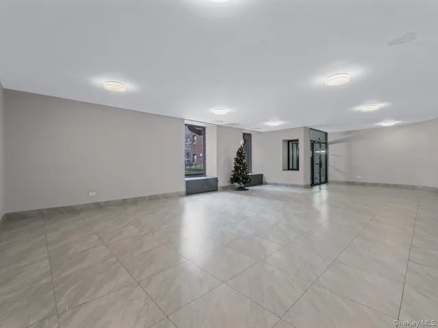 a view of empty room with a kitchen