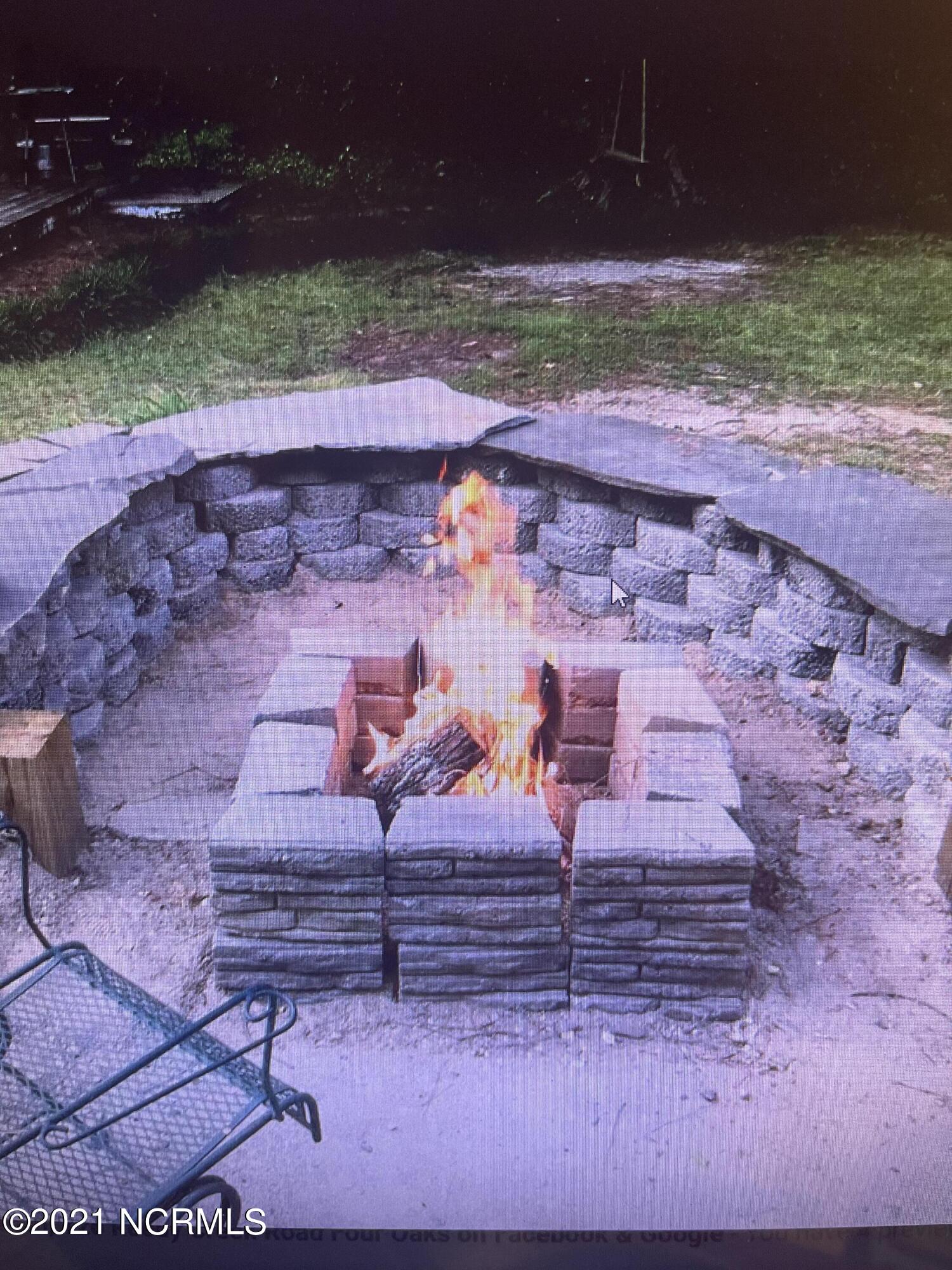 126 Reedy Creek Road Four Oaks, NC 27524 - Photo 27 of 30 Backyard Fire Pit with Built in Seating