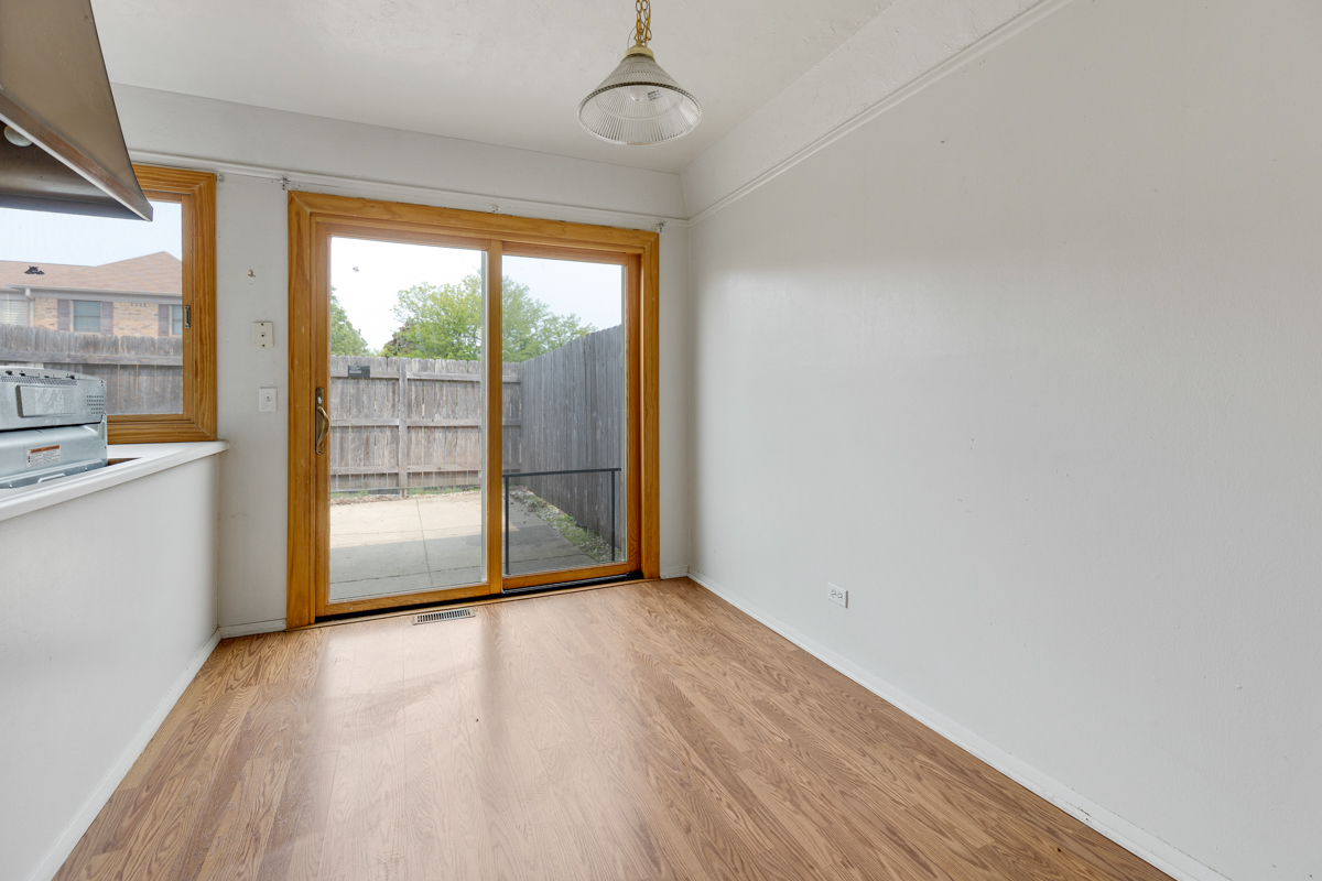 1790 Sessions Walk Hoffman Estates, IL 60169 - Photo 11 of 17 a view of a room with wooden floor and doors