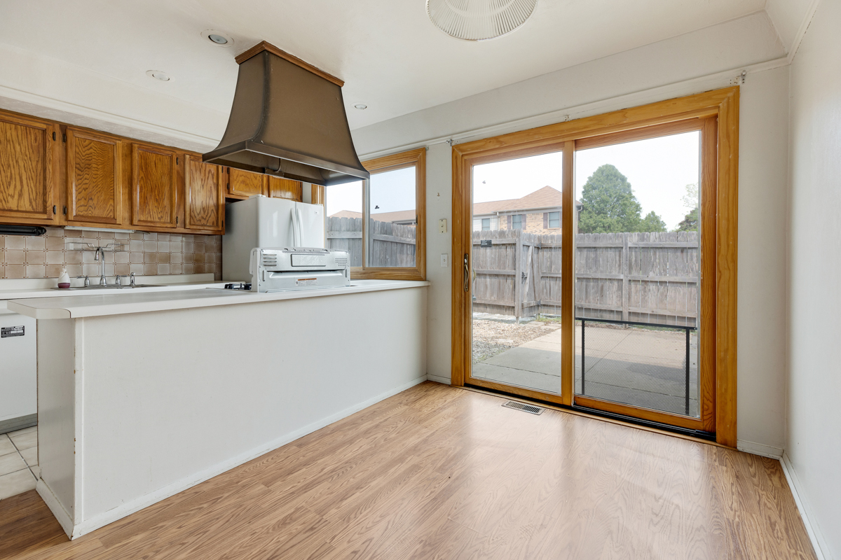 1790 Sessions Walk Hoffman Estates, IL 60169 - Photo 7 of 17 a kitchen with granite countertop a stove a sink and a refrigerator