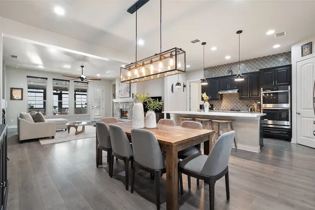 a large kitchen with a table and chairs