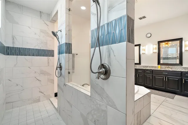 a bathroom with a tub sink and mirror