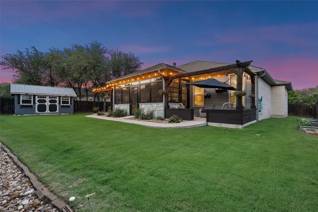 a view of a house with backyard and porch
