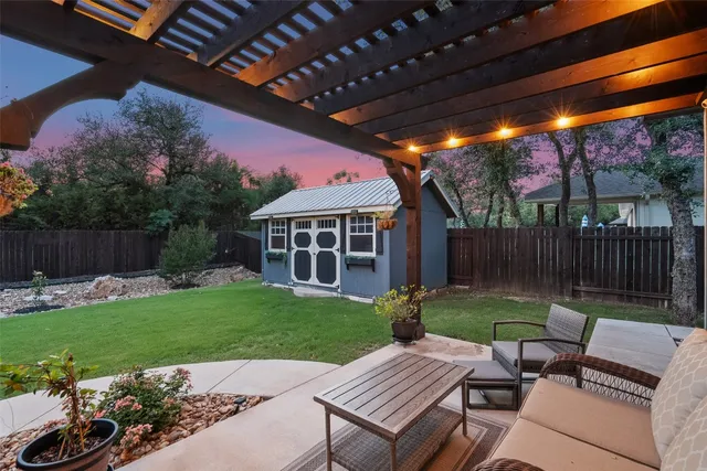 a view of a house with backyard and a sitting area