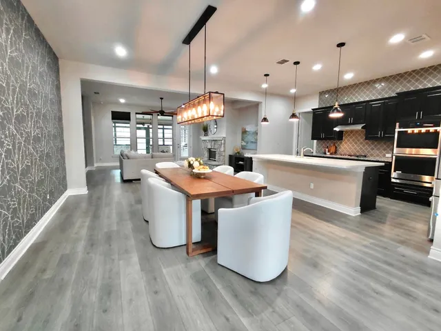 a kitchen with a sink a counter top space stainless steel appliances and a large window