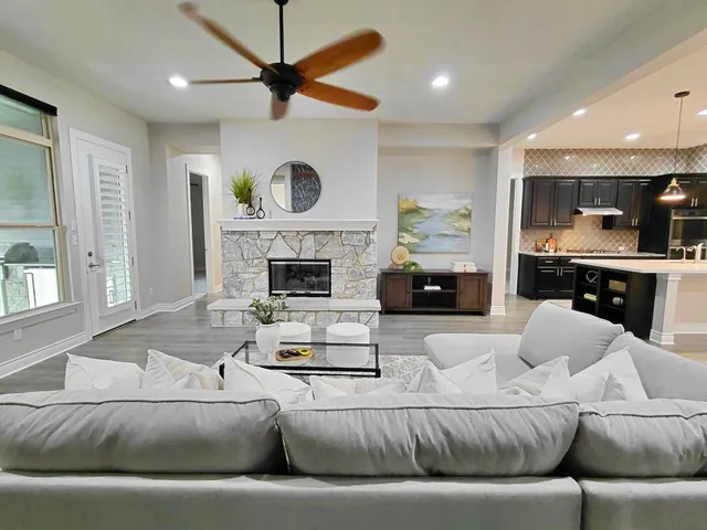 a living room with furniture and a fireplace