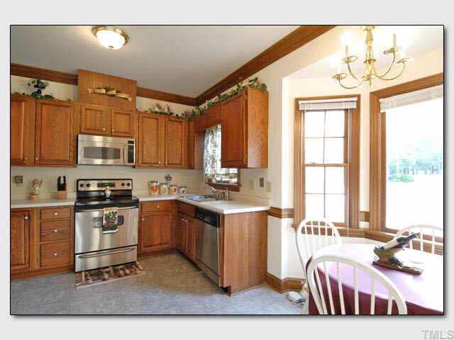 102 Skylark Way Raleigh, NC 27615 - Photo 2 of 10 a kitchen with stainless steel appliances granite countertop a stove a sink and a microwave