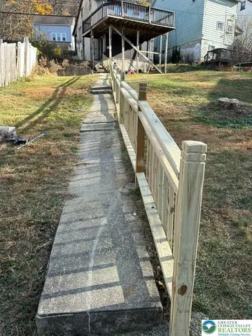 a view of a swimming pool with a yard