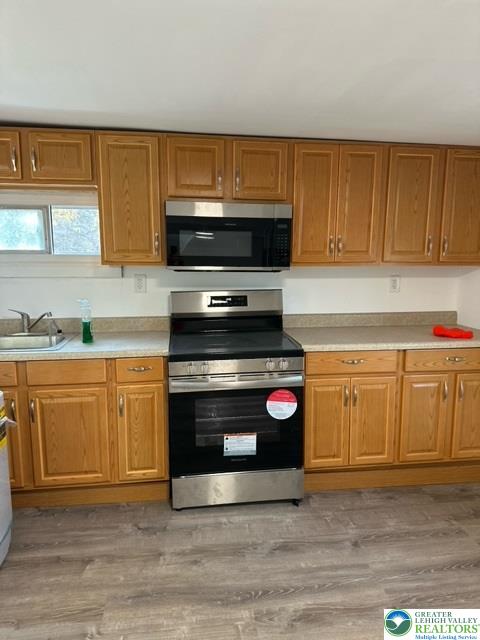 3876 Highway 378, Unit 2 Bethlehem, PA 18015 - Photo 4 of 14 a kitchen with granite countertop a stove top oven microwave and cabinets