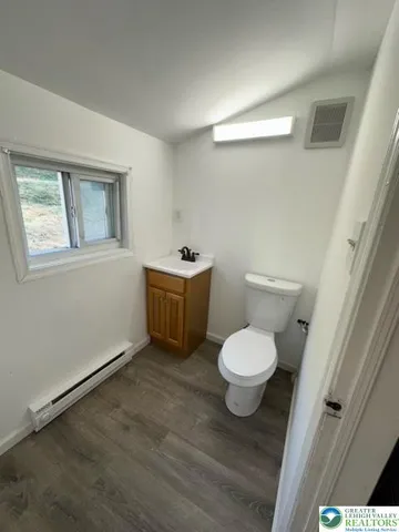 a bathroom with a toilet sink and a mirror