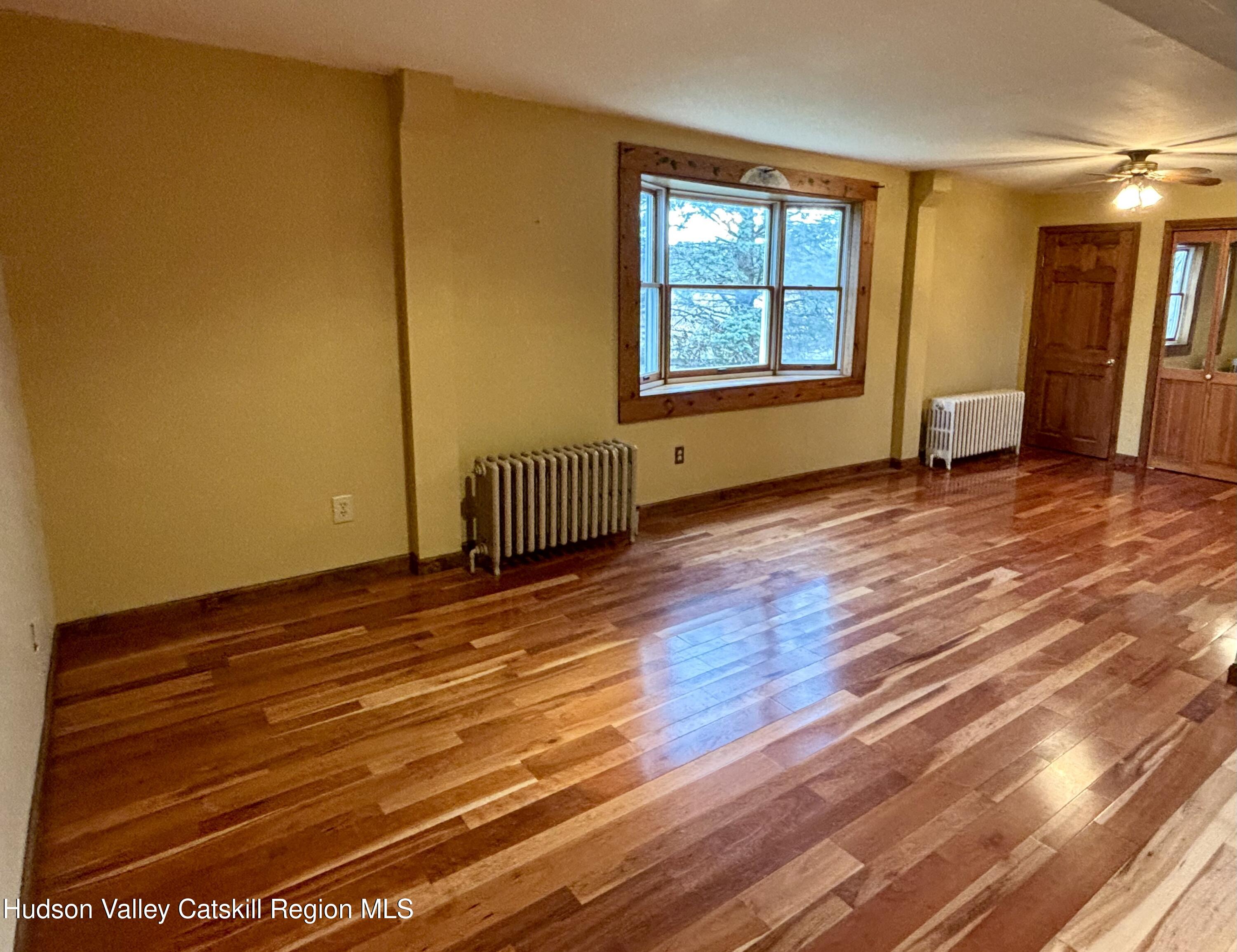470 County Rte 28B Valatie, NY 12184 - Photo 5 of 20 a view of empty room with wooden floor and fan