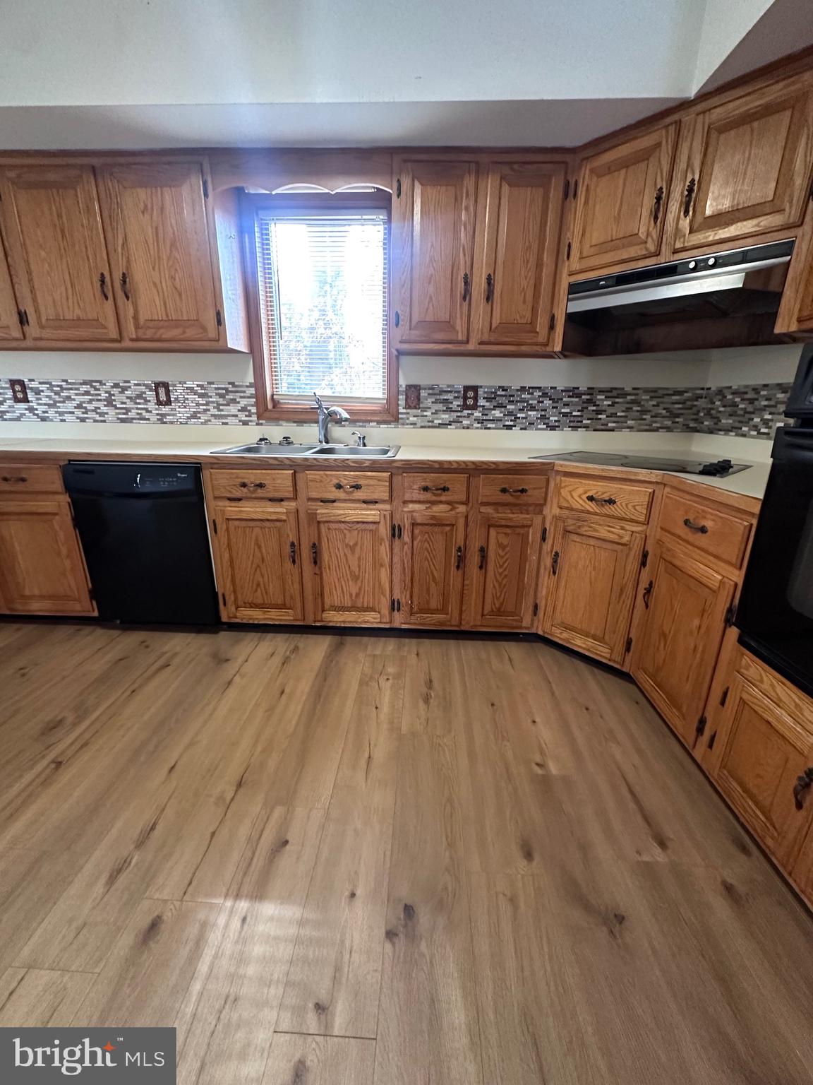 2948 Andrews Lake Road Felton, DE 19943 - Photo 23 of 29 a kitchen with stainless steel appliances granite countertop a stove a sink dishwasher and cabinets with wooden floor