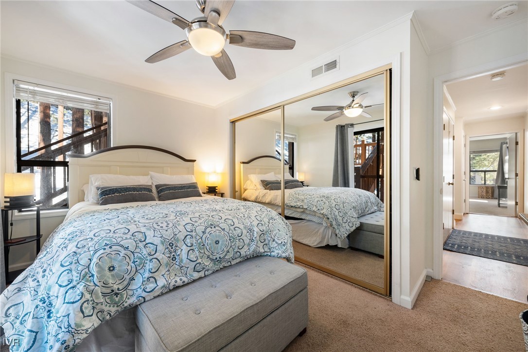 699 Hogan Court, Unit 2 Incline Village, NV 89451 - Photo 14 of 39 a bedroom with a large bed and a chandelier fan