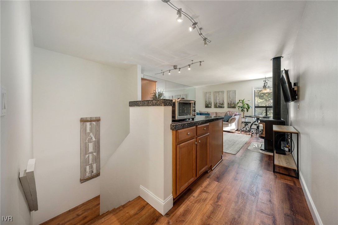 699 Hogan Court, Unit 2 Incline Village, NV 89451 - Photo 26 of 39 a kitchen with stainless steel appliances granite countertop a refrigerator a stove top oven a sink dishwasher and wooden floor