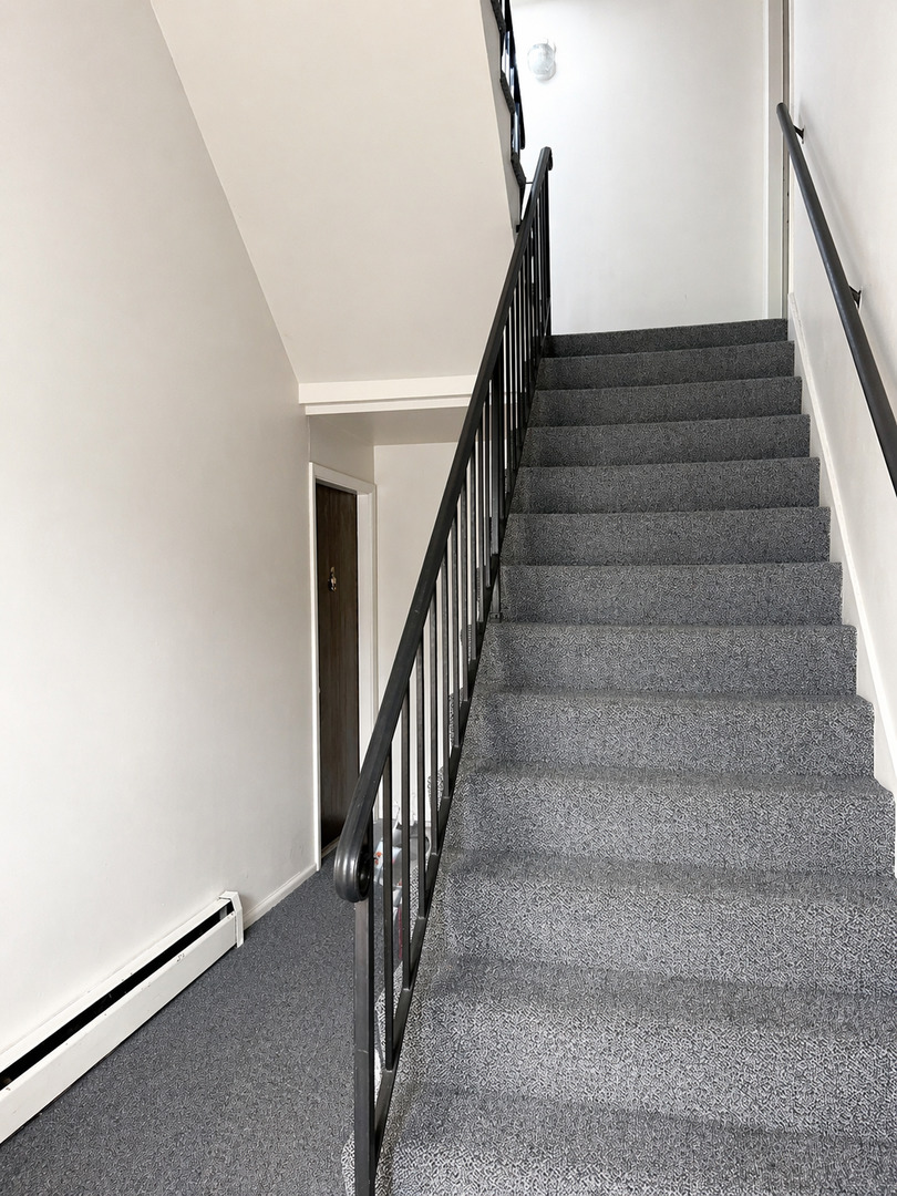 269 7th Street Wheeling, IL 60090 - Photo 24 of 30 a view of staircase with railing and white walls