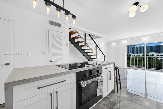 a kitchen that has a lot of cabinets in it
