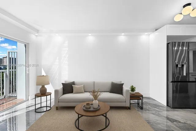 a living room with furniture a refrigerator and a table with wooden floor