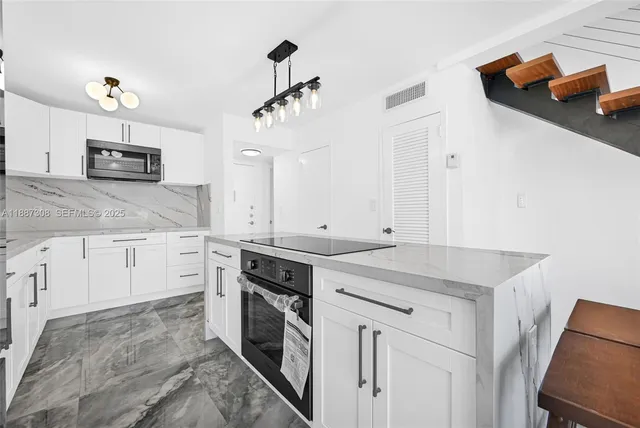 a kitchen with stainless steel appliances granite countertop a sink and cabinets