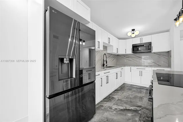 a large kitchen with cabinets and stainless steel appliances