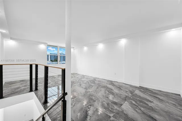 a bedroom with furniture and a painting on the wall