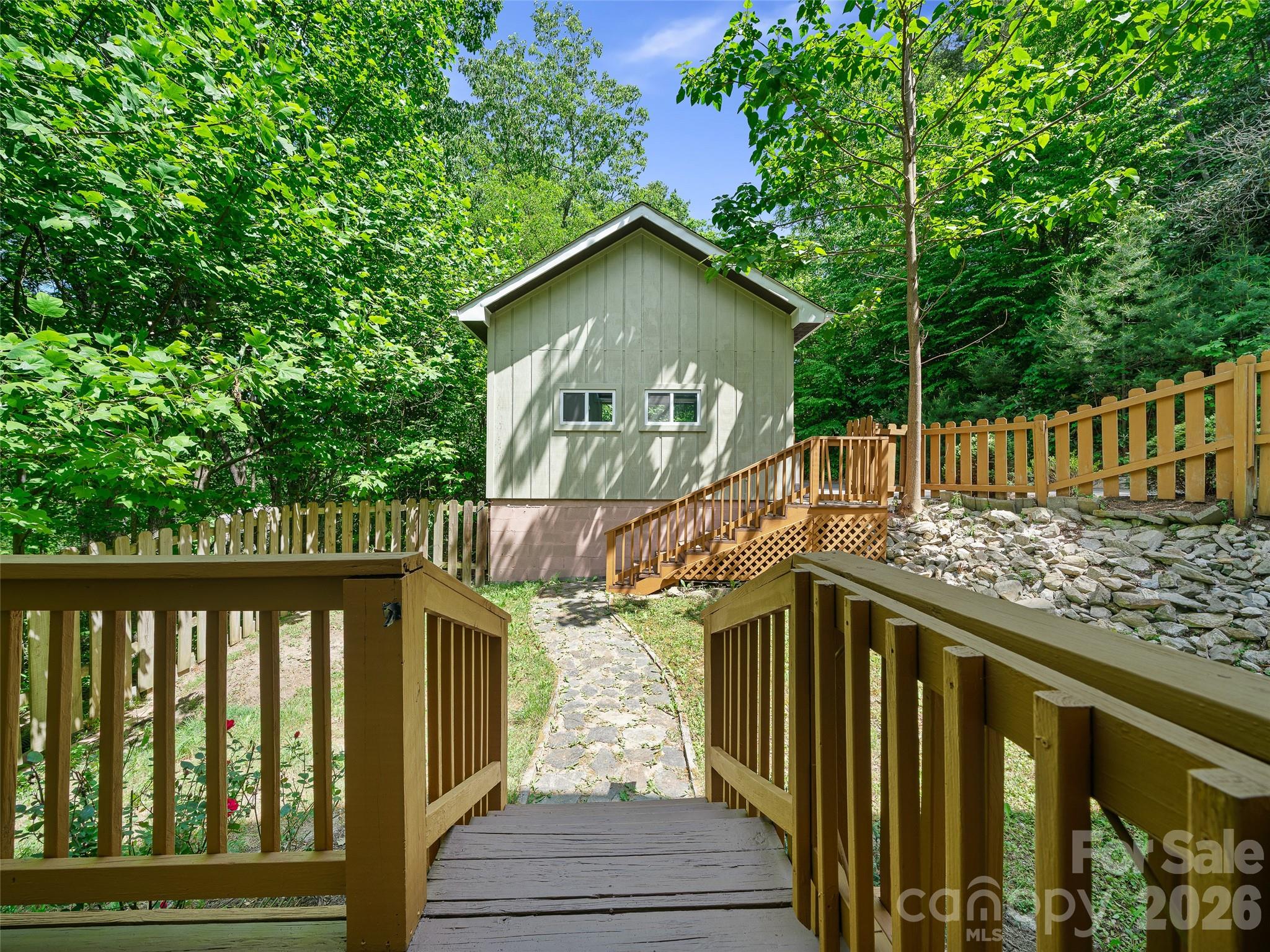 142 Wildflower Road Spruce Pine, NC 28777 - Photo 30 of 46 a view of a wooden house with a small yard