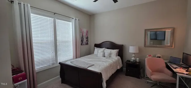 a bedroom with a bed and a chair with the outer view