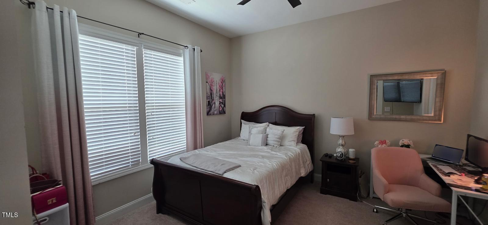 1656 Silo Ridge Drive Wake Forest, NC 27587 - Photo 11 of 17 a bedroom with a bed and a chair with the outer view