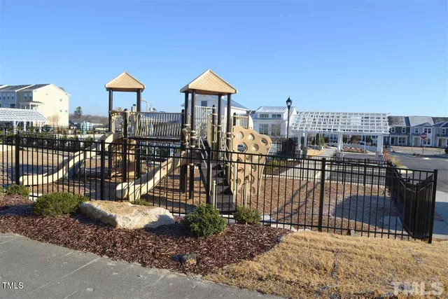 a front view of a house with a iron gate