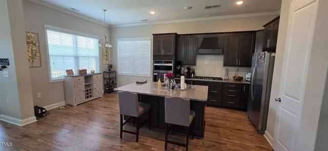 a kitchen with a table and chairs in it