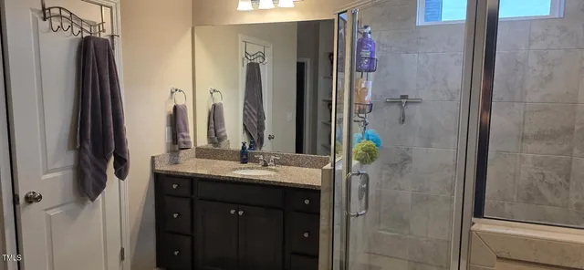 a bathroom with a double vanity sink and a mirror