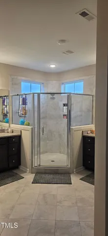 a living room with stainless steel appliances kitchen island granite countertop a refrigerator and cabinets