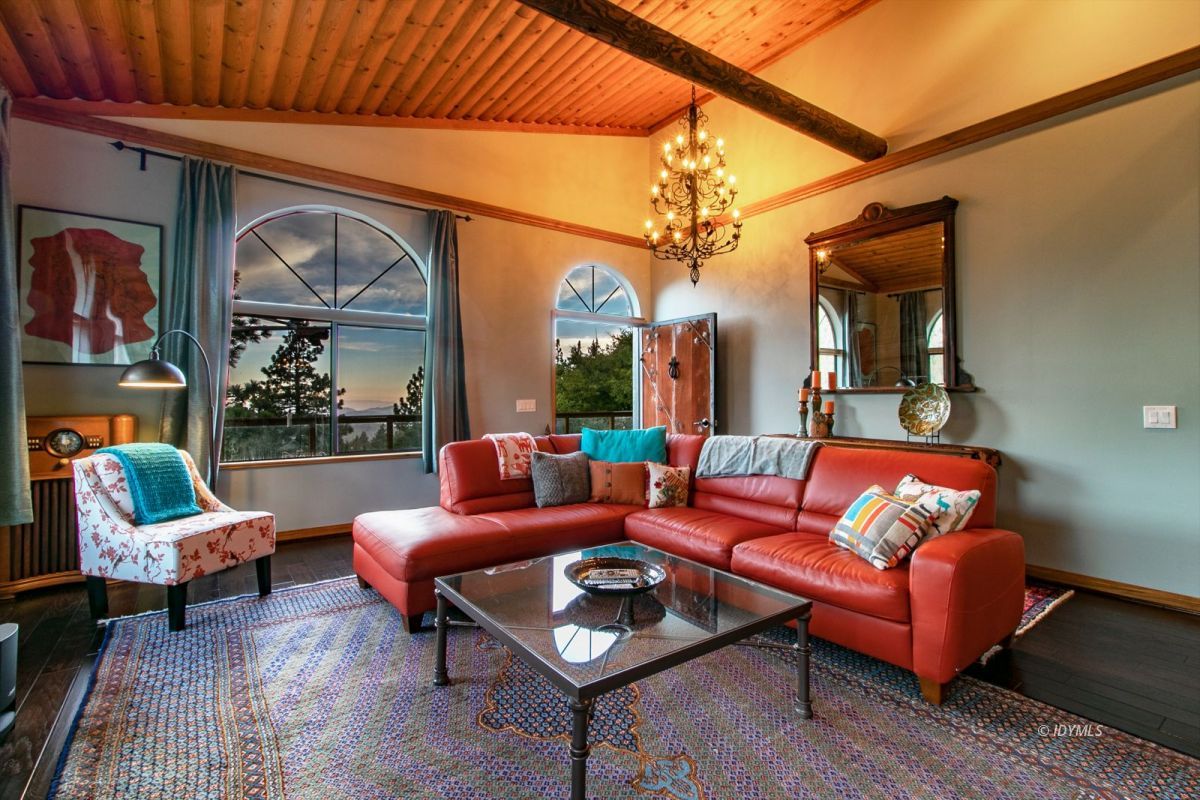 54850 Chipmunk Drive Idyllwild, CA 92549 - Photo 11 of 44 a living room with furniture a wooden floor and a large window
